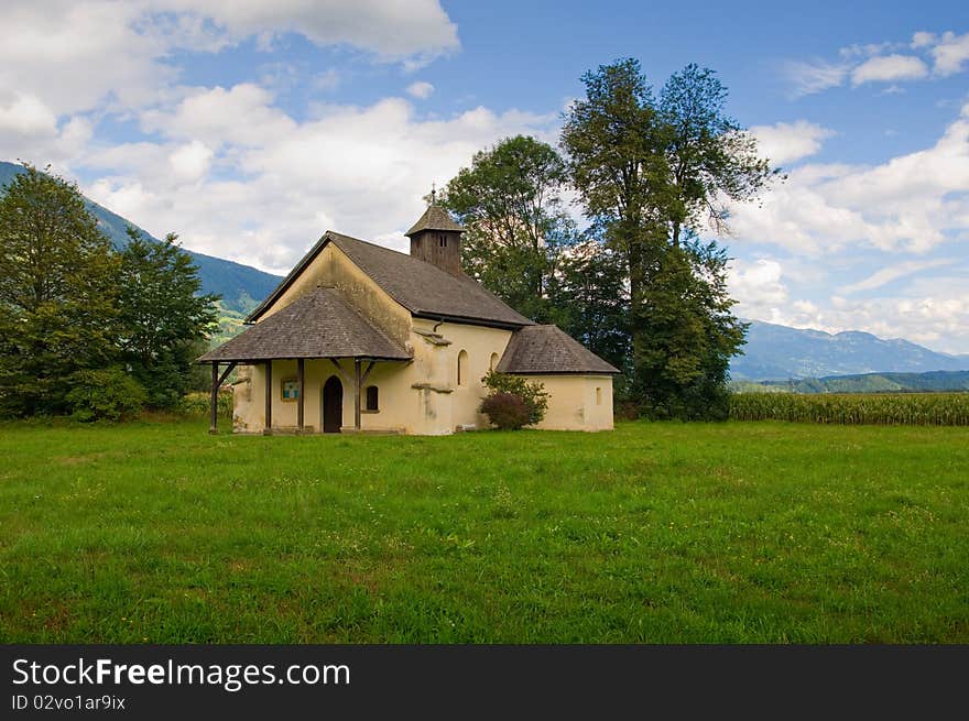 Countryside's church. mountains landscape on background