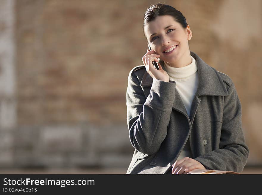 Young woman on mobile phone, outdoors