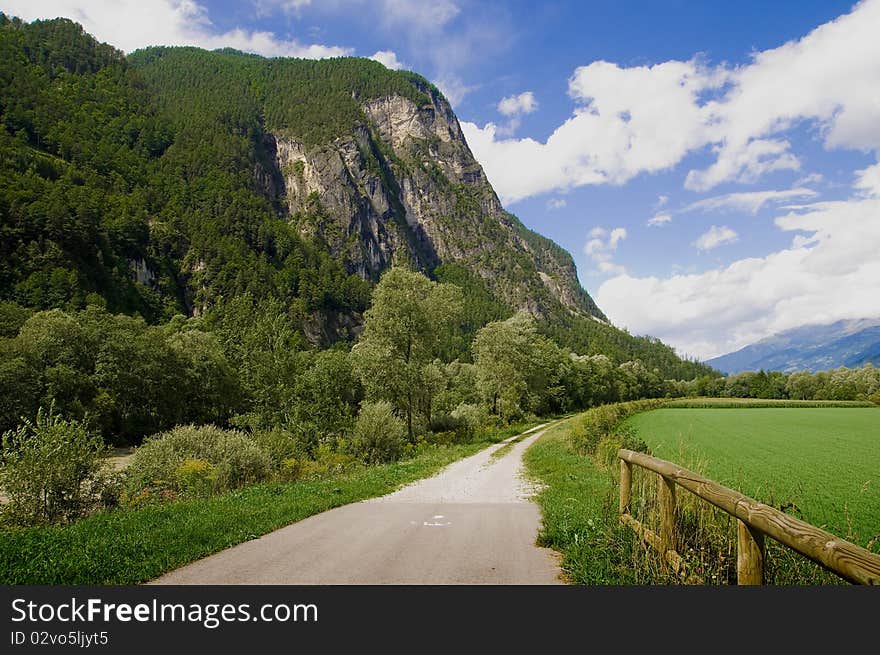 Drava road cycling landscape. Mountains, sky and clouds on background