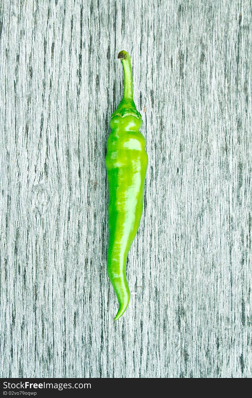 Green chilli pepper on a cutting board