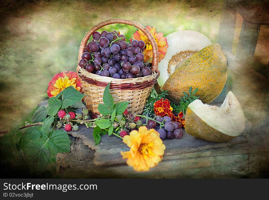 Vine, melon, raspberry flowers on a table. Vine, melon, raspberry flowers on a table