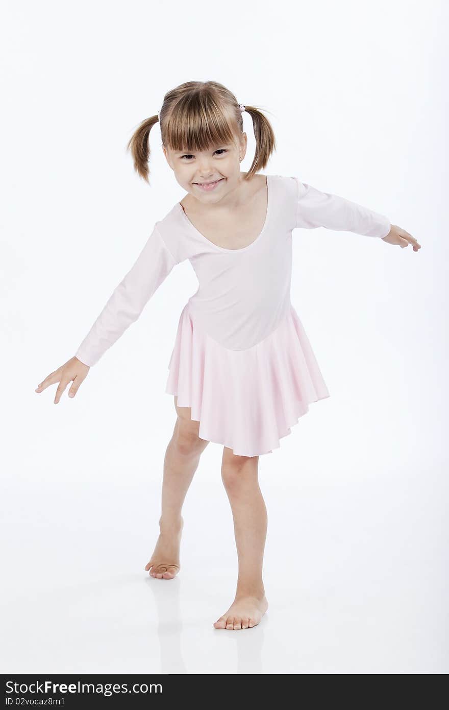 Full lenght portrait of a little ballerina dancing and smiling. Full lenght portrait of a little ballerina dancing and smiling