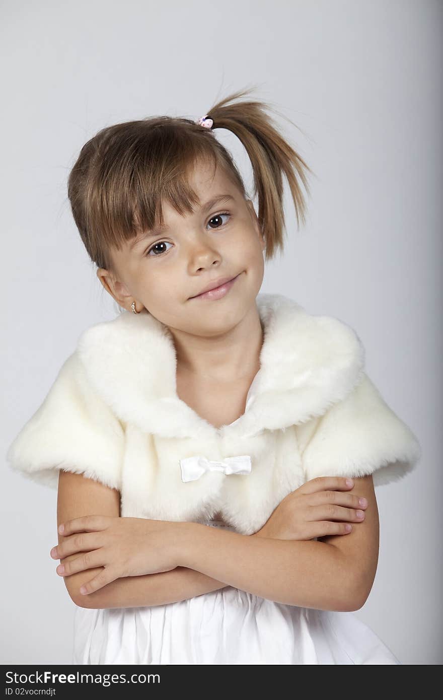 Portrait of a fashionable little girl, studio image. Portrait of a fashionable little girl, studio image