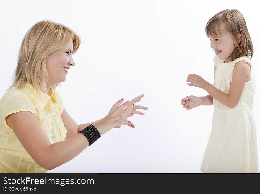 Young beautiful mother playing with her daughter