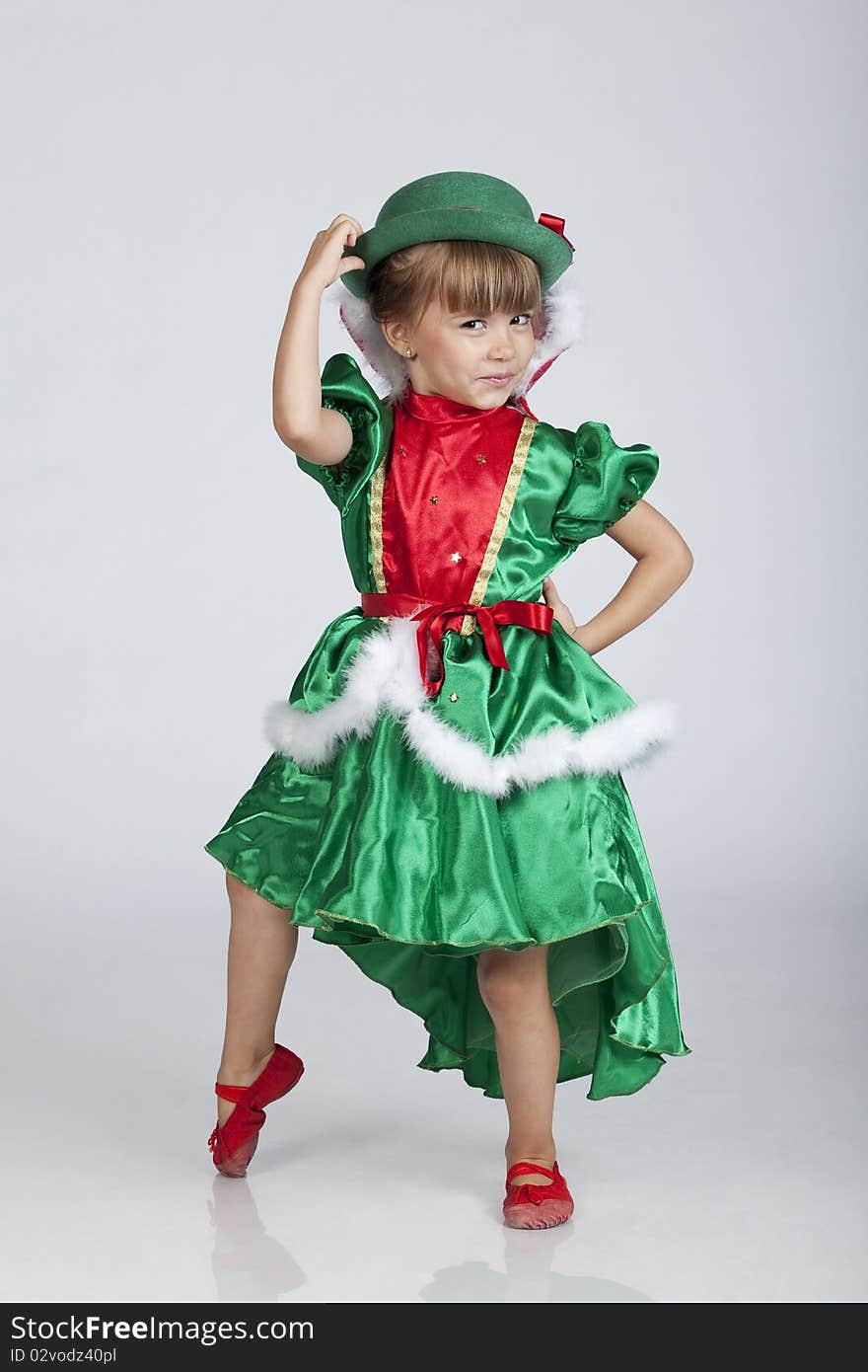 Full length portrait of an adorable little girl wearing green outfit and hat for Saint Patrick's Day, studio image. Full length portrait of an adorable little girl wearing green outfit and hat for Saint Patrick's Day, studio image