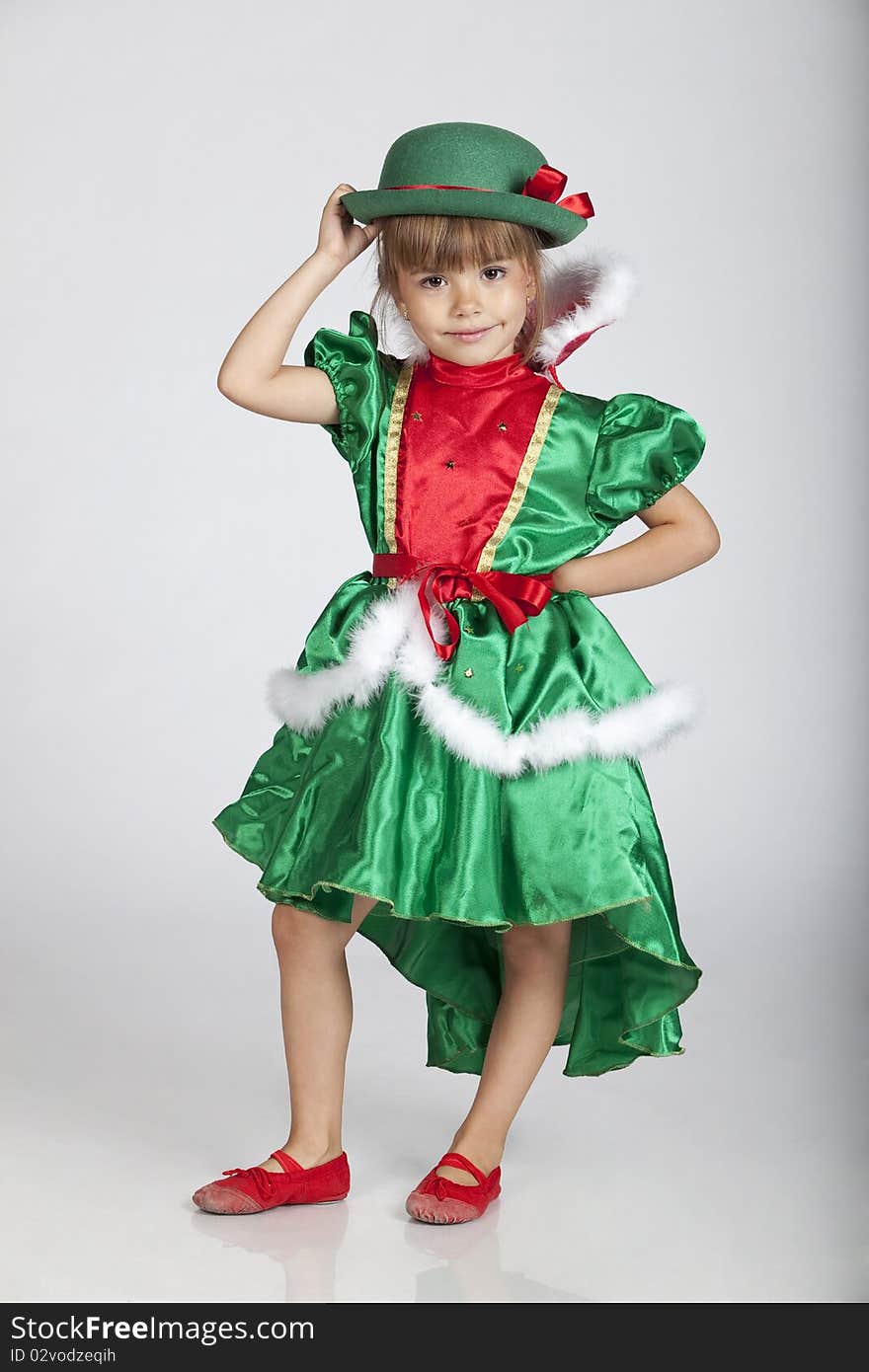 Full length portrait of an adorable little girl wearing green outfit and hat for Saint Patrick's Day, studio image. Full length portrait of an adorable little girl wearing green outfit and hat for Saint Patrick's Day, studio image