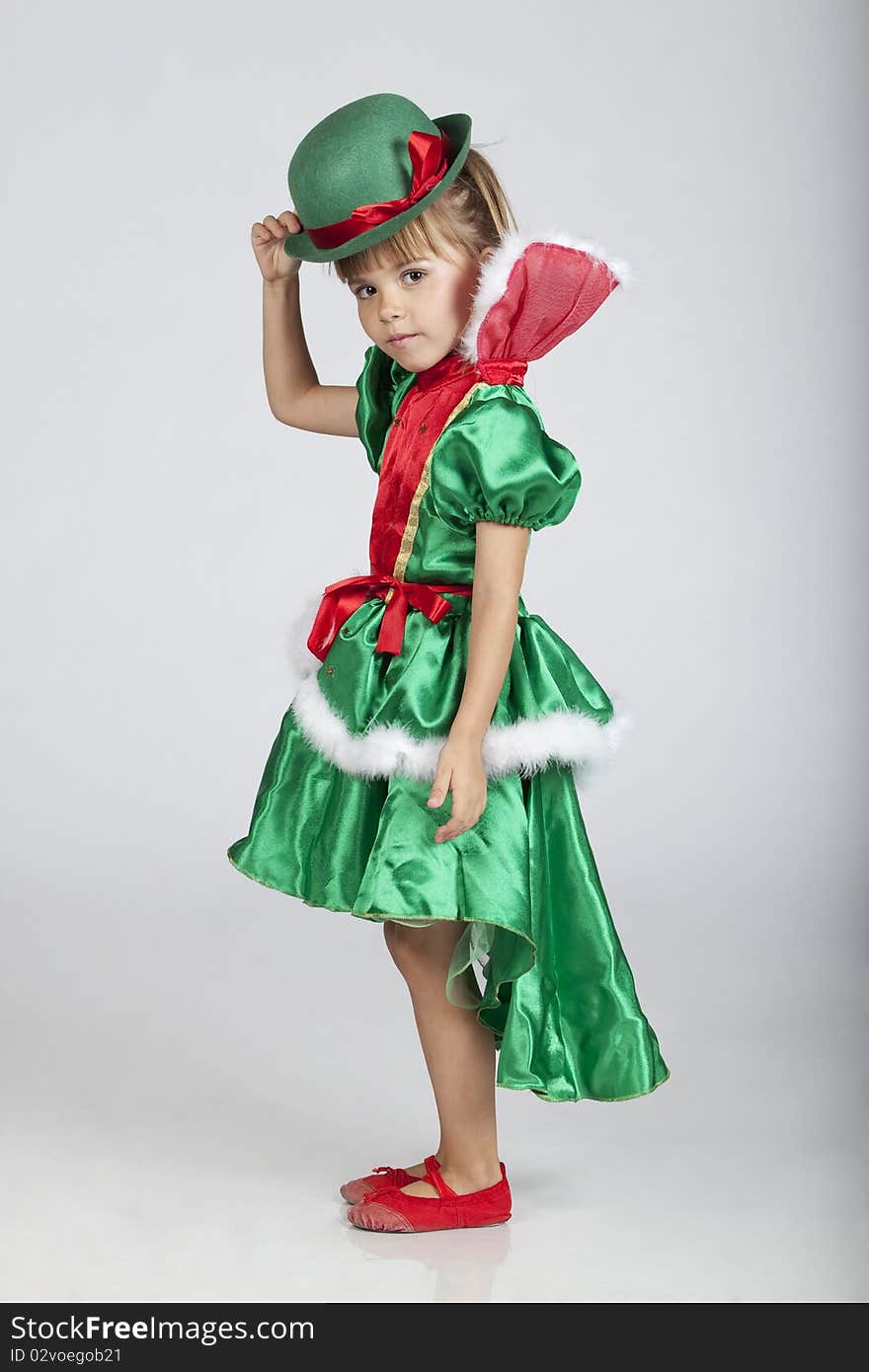 Full length portrait of an adorable little girl wearing green outfit and hat for Saint Patrick's Day, studio image. Full length portrait of an adorable little girl wearing green outfit and hat for Saint Patrick's Day, studio image