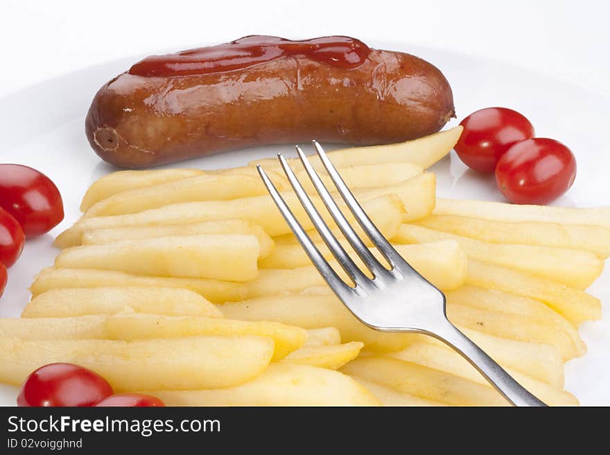 Fried potato with tomatoes and sausage on a plate.