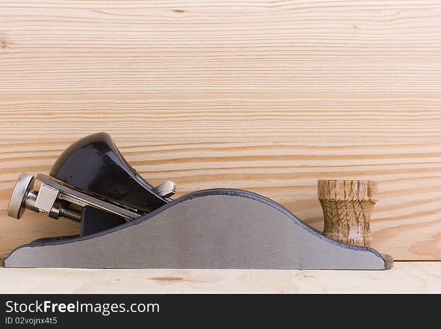 Handplane next to a piece of wood. Add your text to the background.