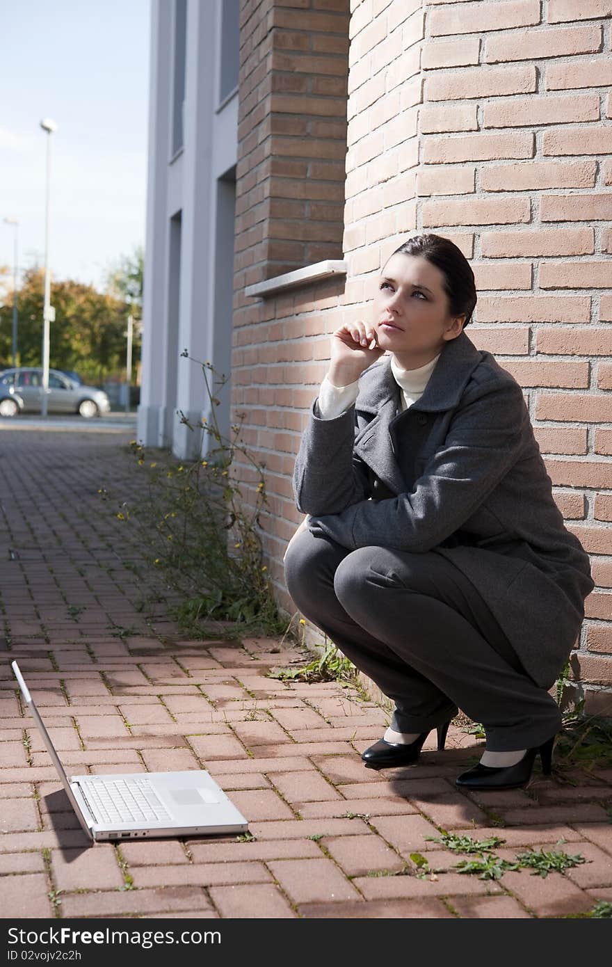 Young business woman with notebook, outdoors