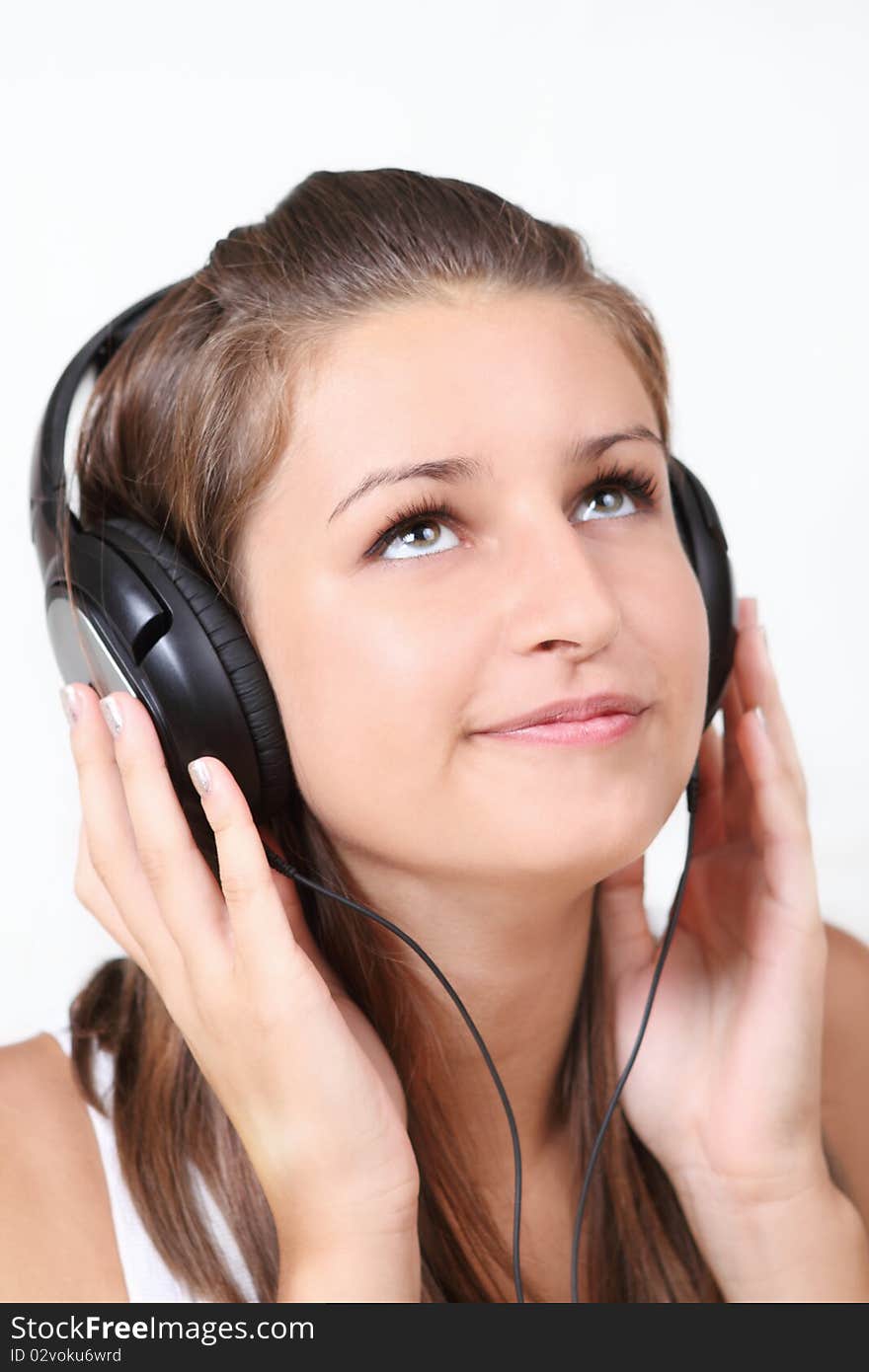 Portrait of the brunette beauty smilling girl wearing headphones. Portrait of the brunette beauty smilling girl wearing headphones