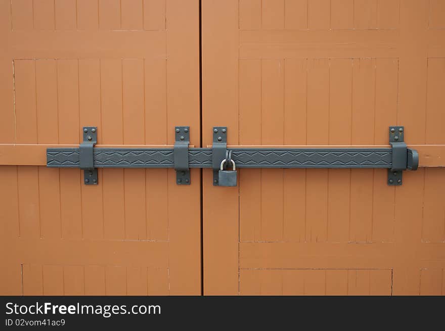 Detail of a wooden door with an iron bolt. Detail of a wooden door with an iron bolt