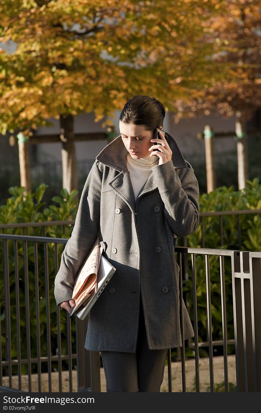 Young woman on the mobile phone, outdoors