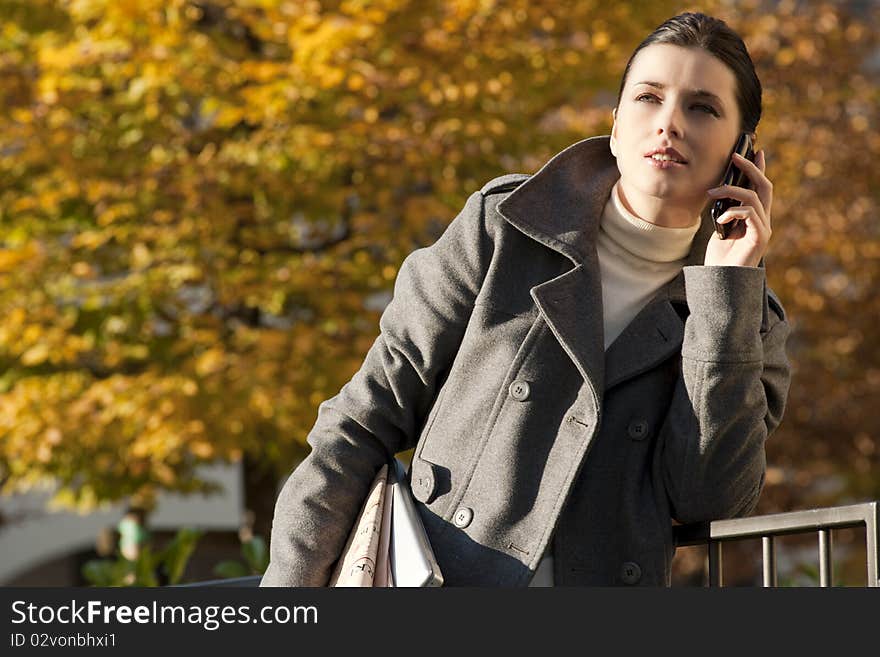 Young woman on the mobile phone, outdoors