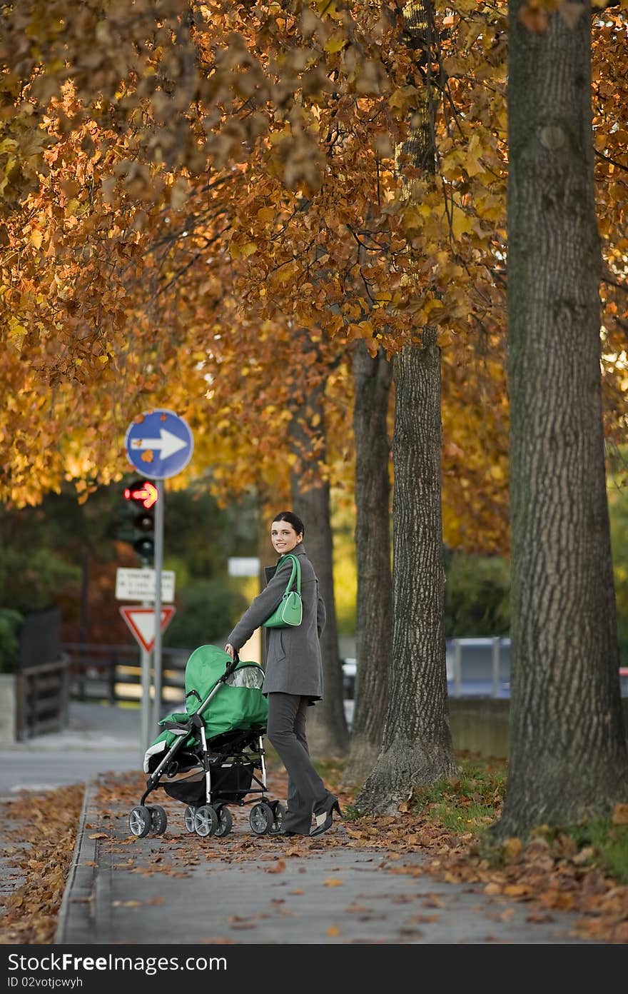 Young woman walking her child through the city. Young woman walking her child through the city