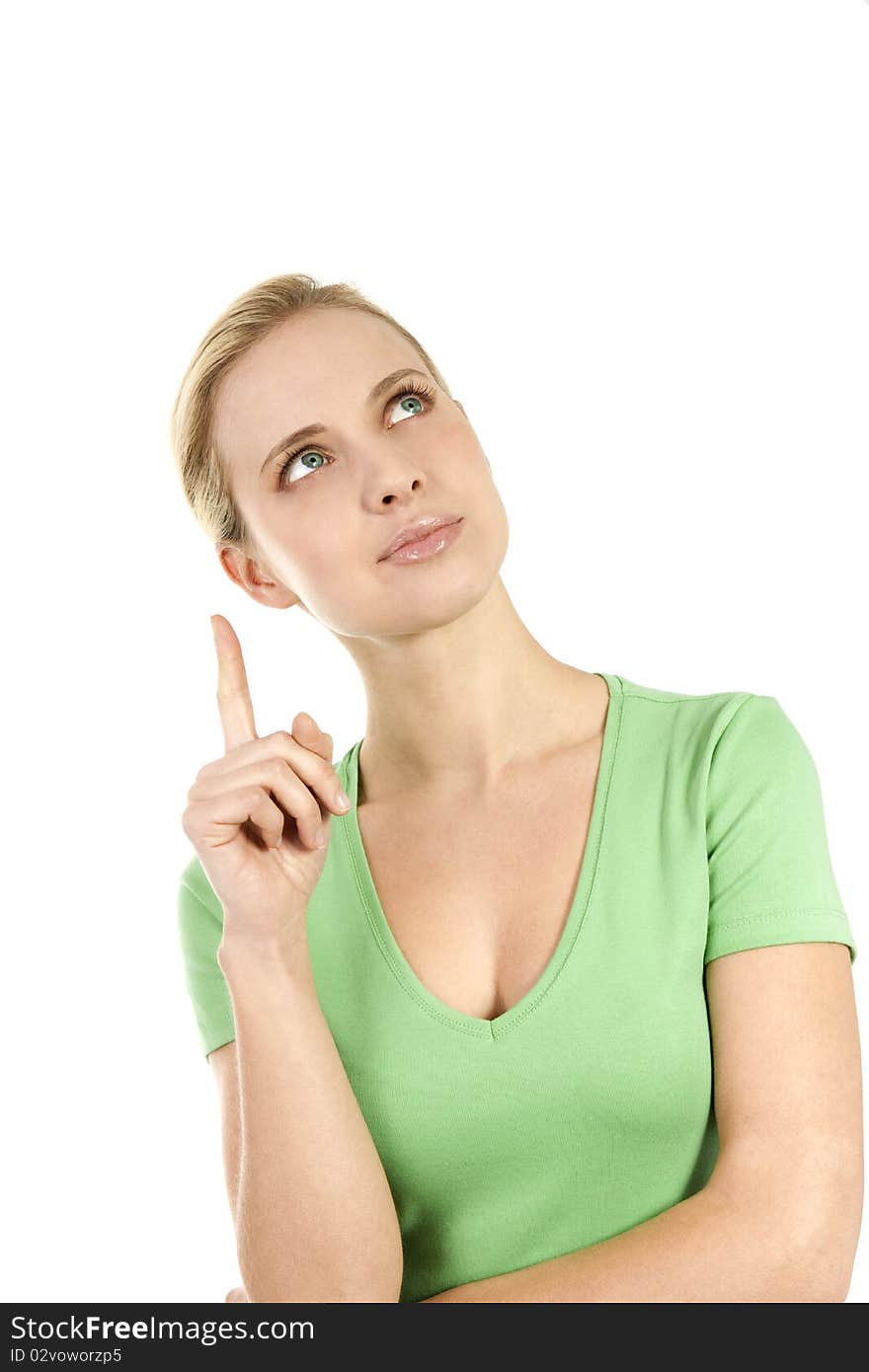 Young woman pointing at copy space; she is green dressed, maybe pointing at something concerned with nature and environment