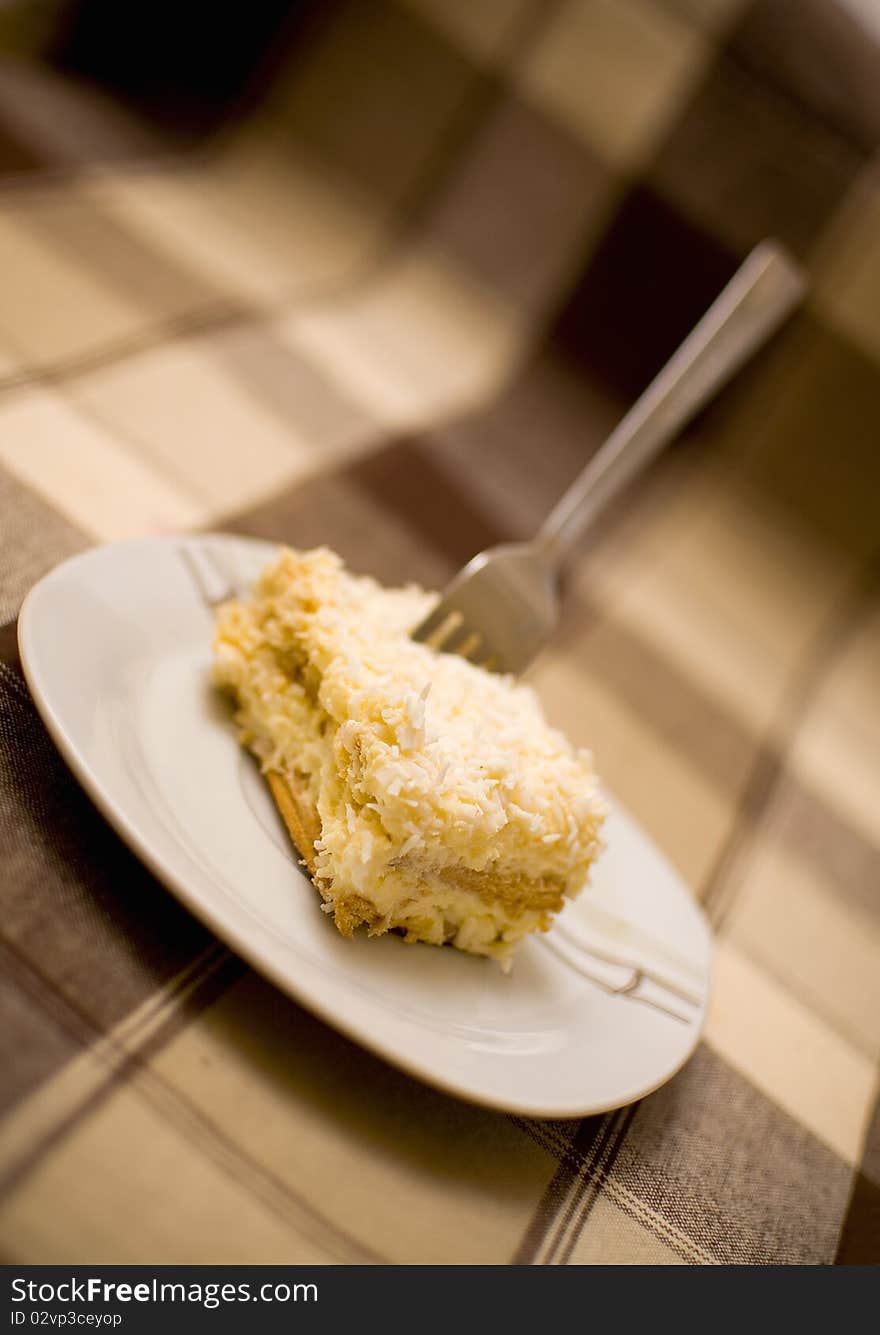 Pice of cake with fork in it, blurred background. Pice of cake with fork in it, blurred background