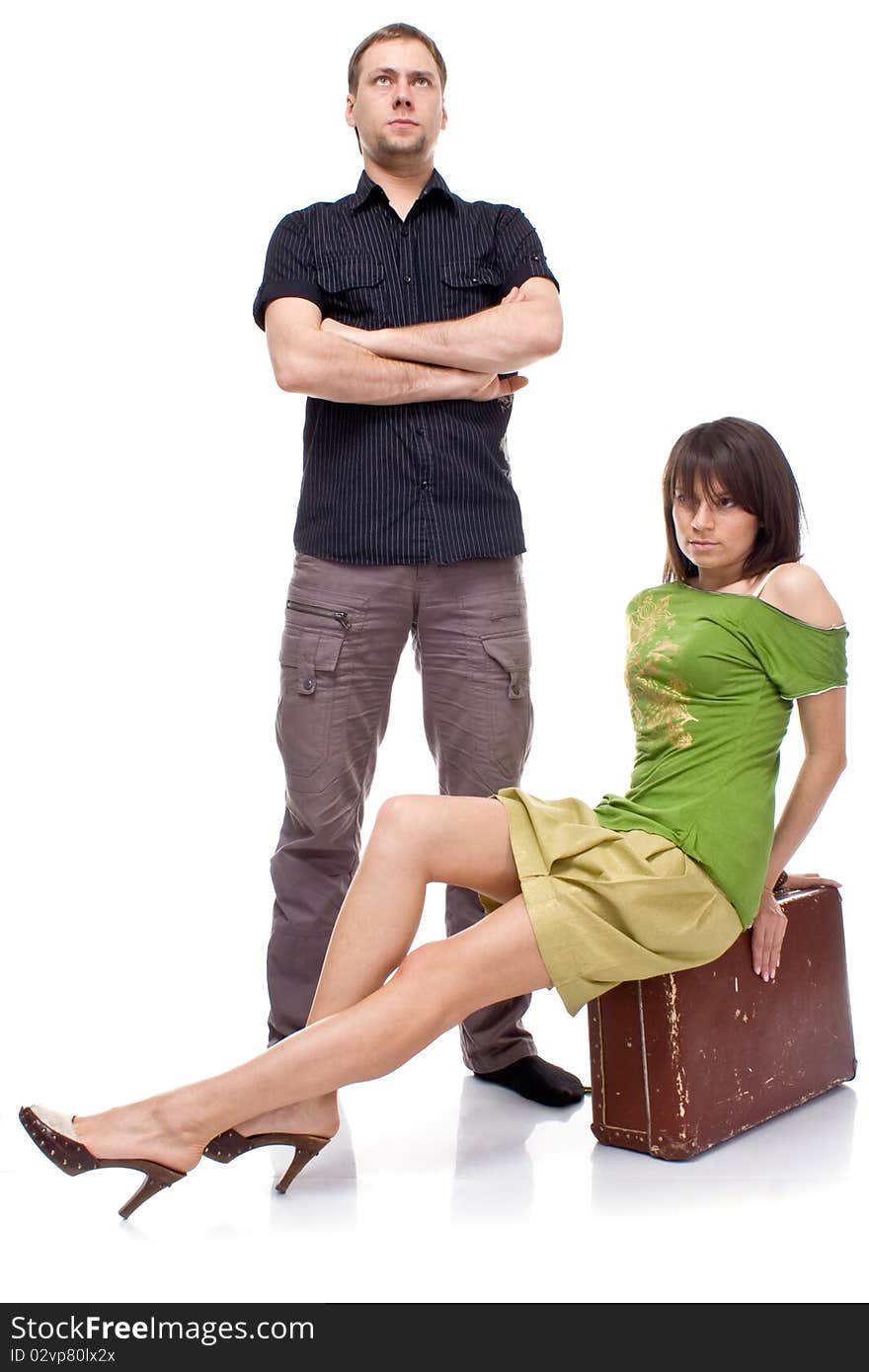 A married couple with a suitcase on white background