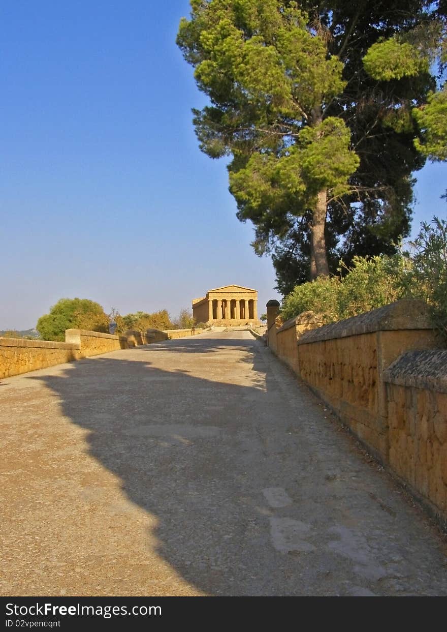 Road in the open air archaeological museum of  Valle dei templi near Agrigento (Sicily, Italy, Europe) leading to the sunlit  and ancient Greek temple of Concordia 

*with space for text (copyspace). Road in the open air archaeological museum of  Valle dei templi near Agrigento (Sicily, Italy, Europe) leading to the sunlit  and ancient Greek temple of Concordia 

*with space for text (copyspace)