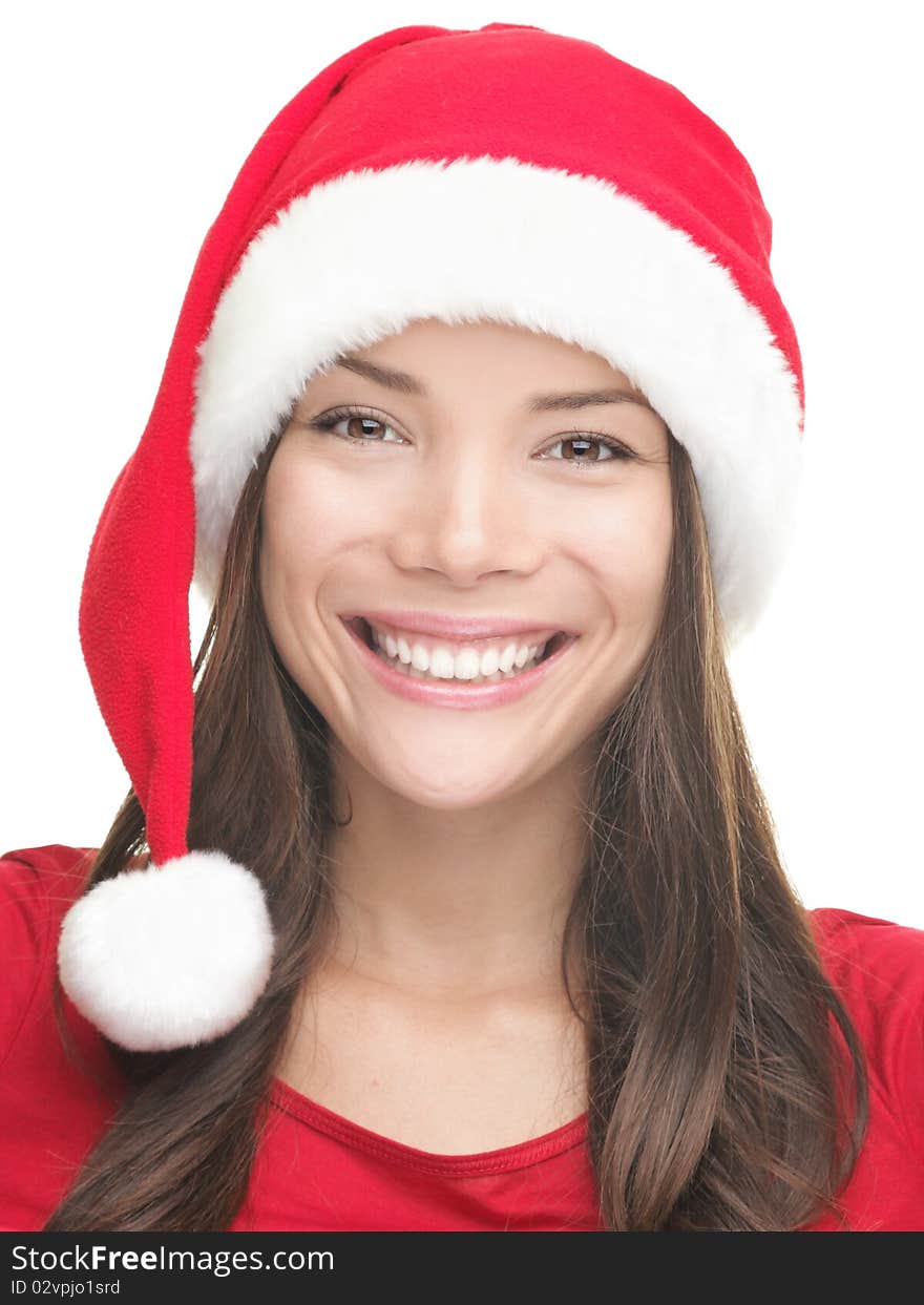 Christmas girl smiling. Portrait of cute young smiling asian woman wearing Santa hat.Isolated on white background.