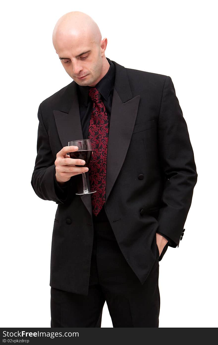 Young business man in dark suit holding a glass of wine. Young business man in dark suit holding a glass of wine