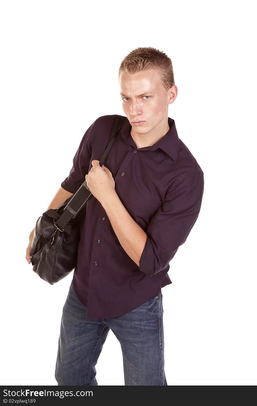 A young man with a serious expression on his face carring a duffel bag. A young man with a serious expression on his face carring a duffel bag.