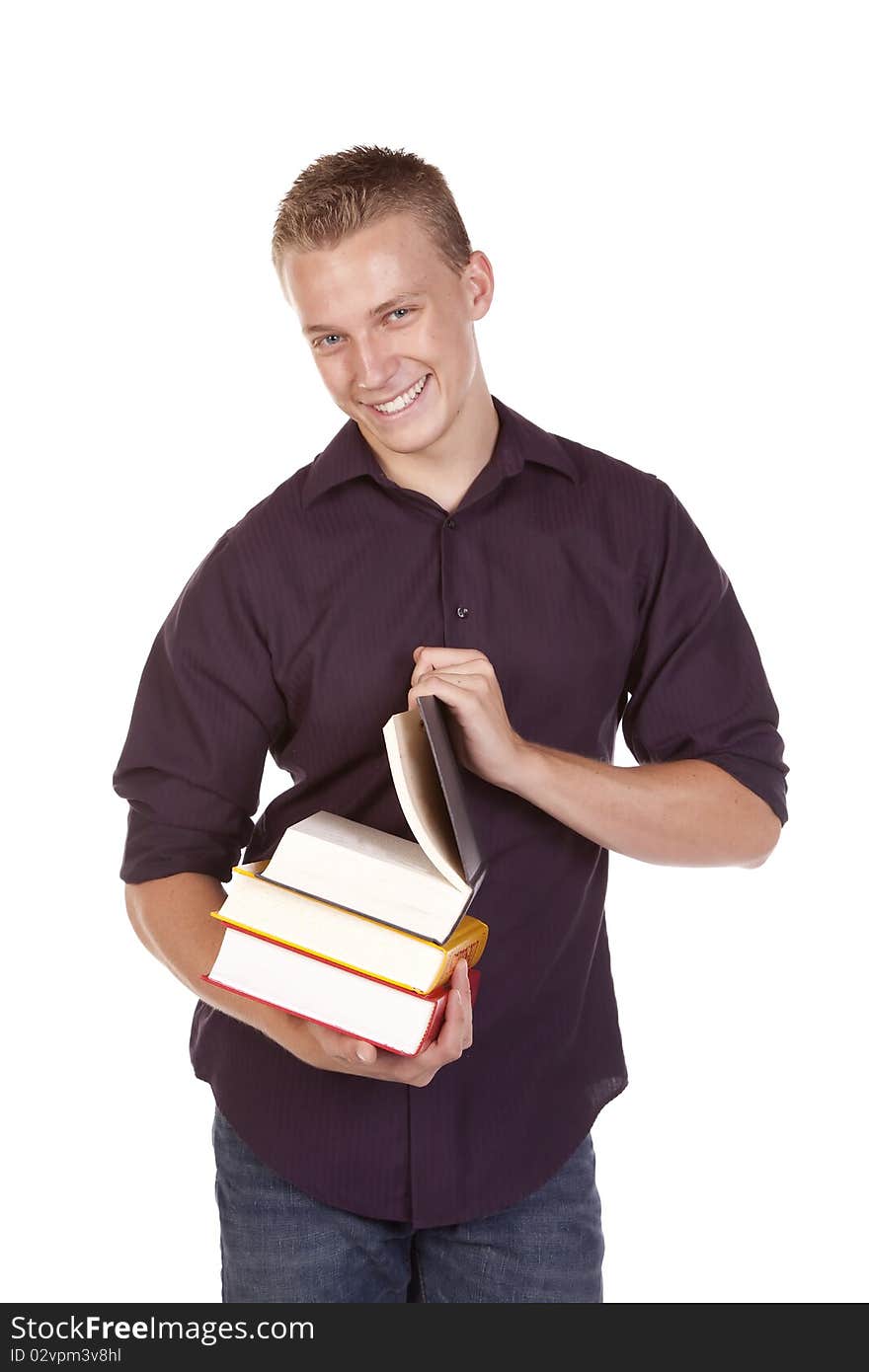 A young college student with a stack of books in his hands getting ready to read. A young college student with a stack of books in his hands getting ready to read.