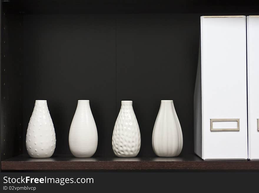 Wooden shelf with white vases. Wooden shelf with white vases