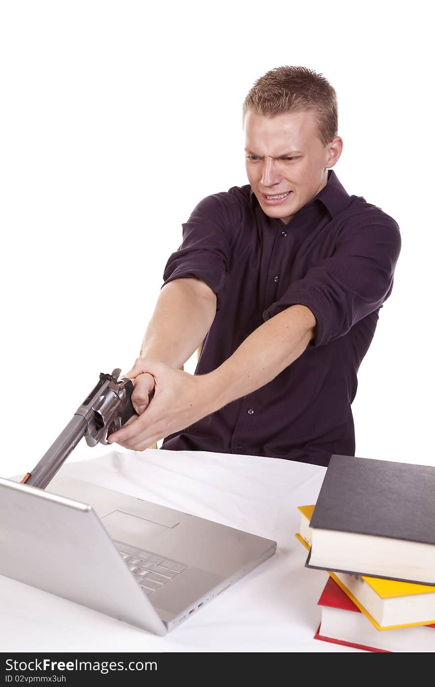 A young man getting ready to shoot his computer because he is so mad. A young man getting ready to shoot his computer because he is so mad.