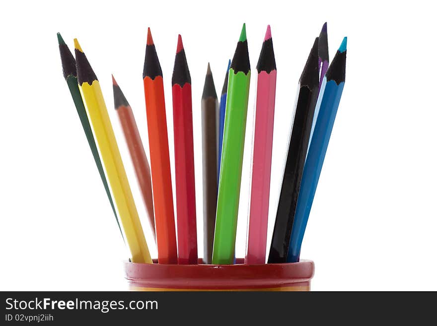 Colored pencils in a cup isolated over white background