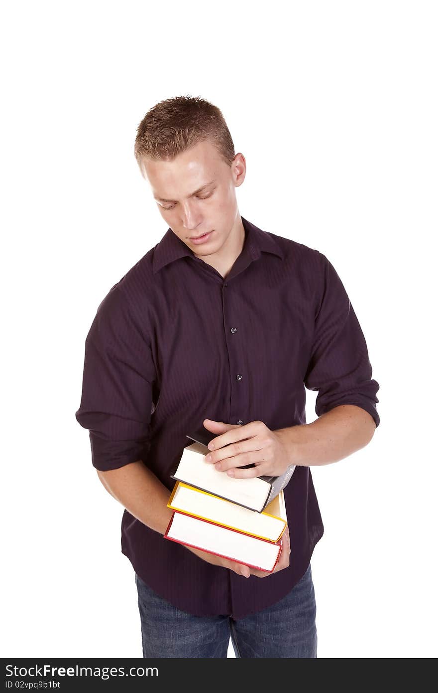 A young college student with a stack of books in his hands getting ready to read. A young college student with a stack of books in his hands getting ready to read.