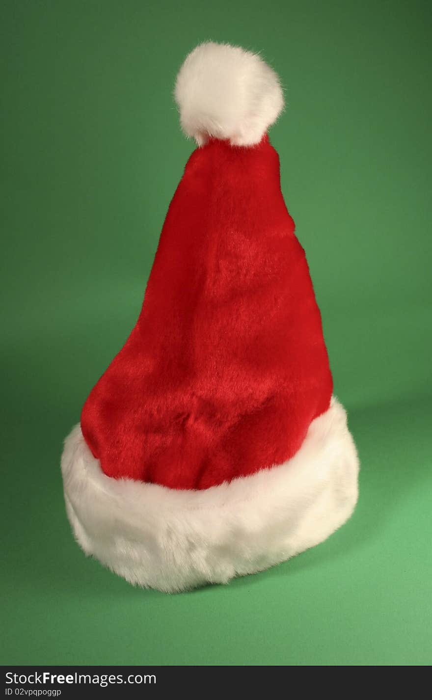 Red fur cap shot on a green background, perfect for chris kringle or any of his elves. Red fur cap shot on a green background, perfect for chris kringle or any of his elves.