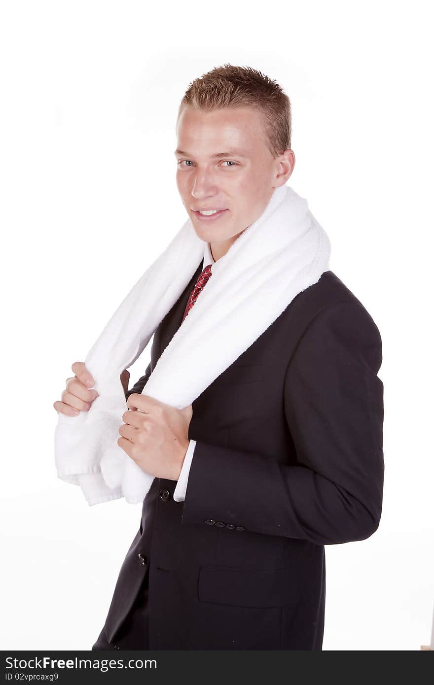 A young business man smiling with a towel on his shoulders. A young business man smiling with a towel on his shoulders.