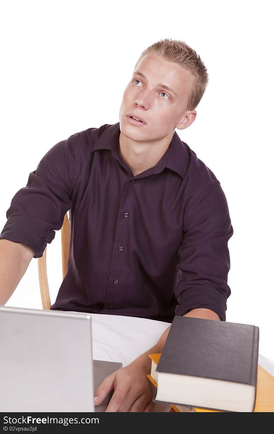 A young man tired of studing and working on his computer. A young man tired of studing and working on his computer.