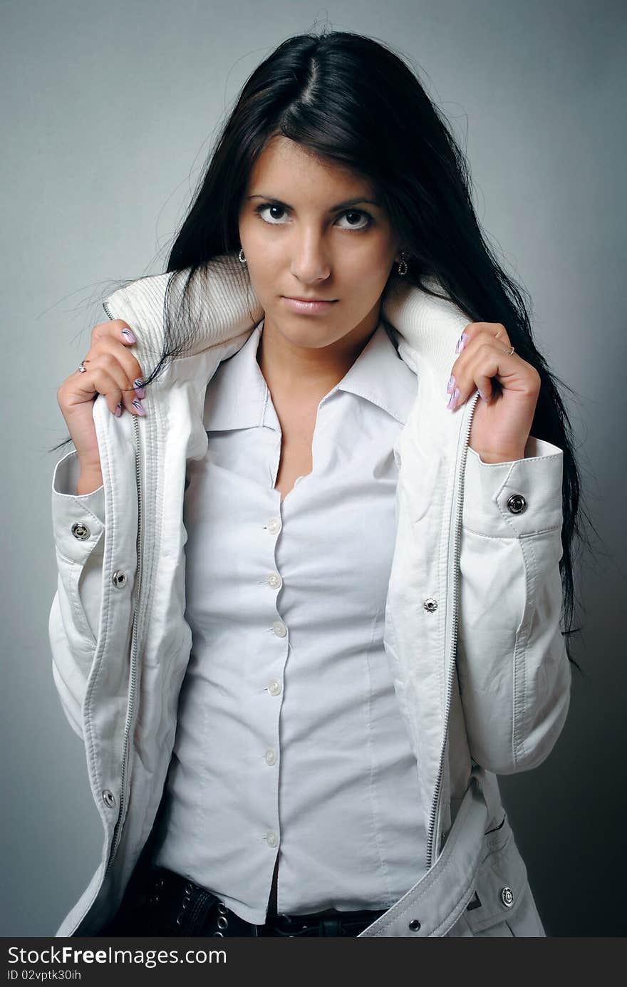 Portrait of a beautiful fashion female model with a white jacket. Portrait of a beautiful fashion female model with a white jacket