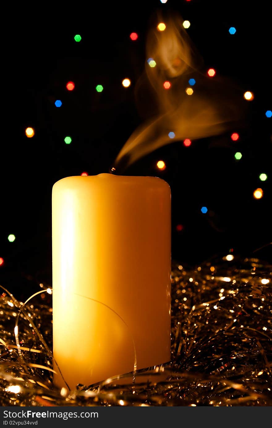 The smoke rises from candles on a dark abstract background. The smoke rises from candles on a dark abstract background