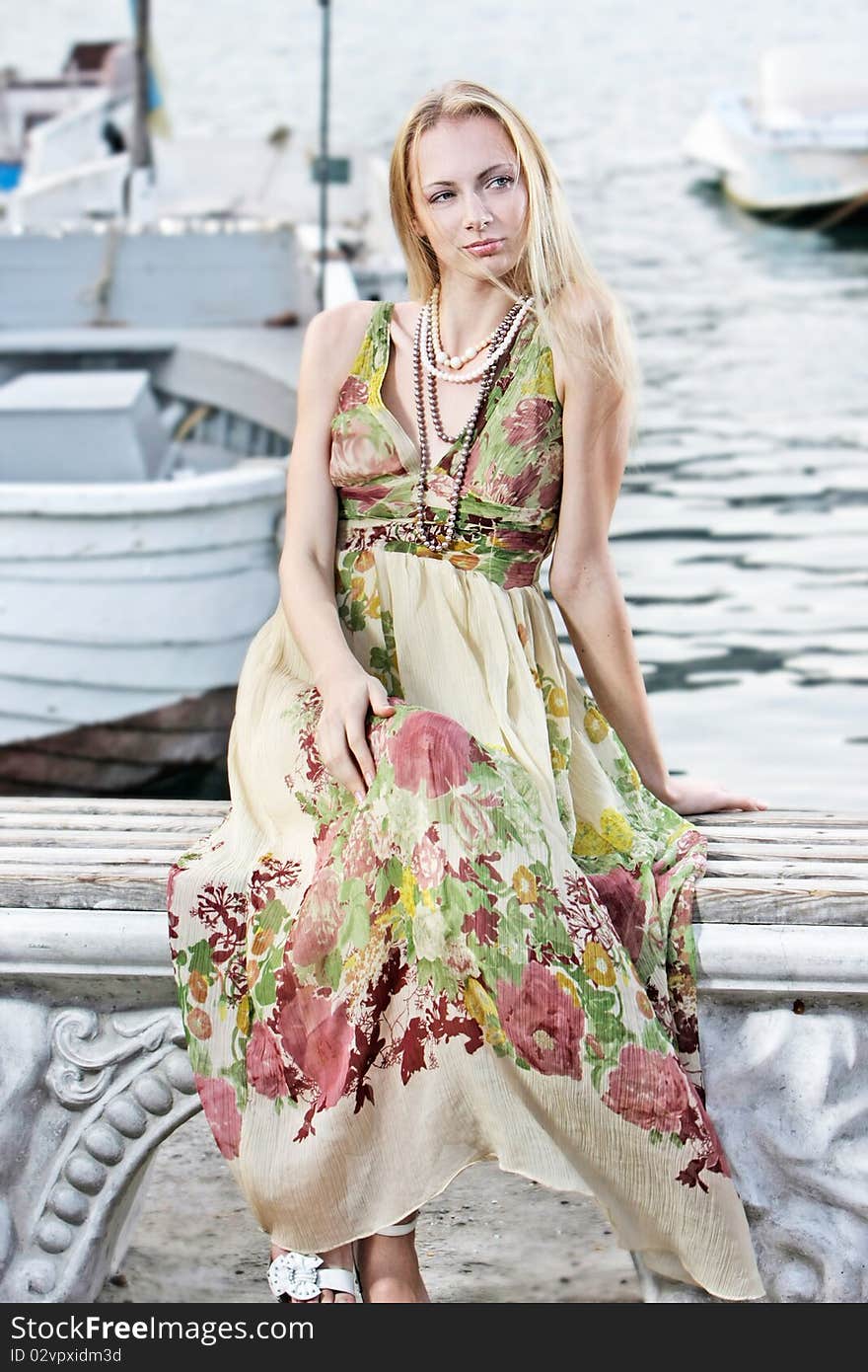 Young attractive woman on pier background