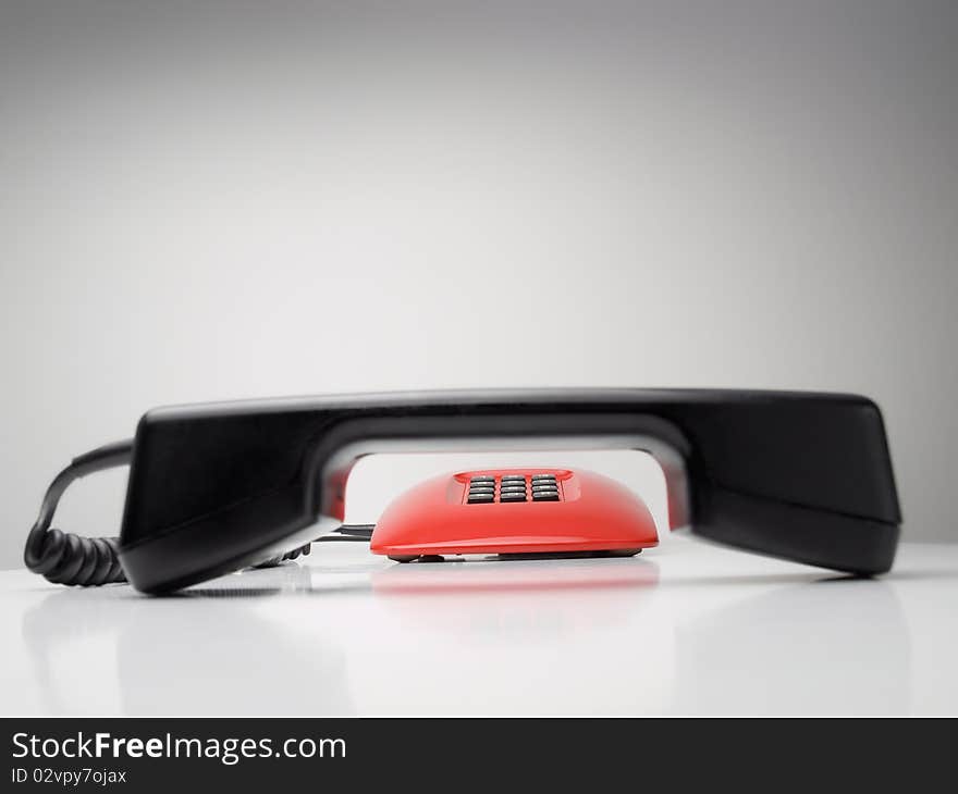 Red telephone with focus on the dial buttons in the background, for communication,emergency or service themes. Red telephone with focus on the dial buttons in the background, for communication,emergency or service themes