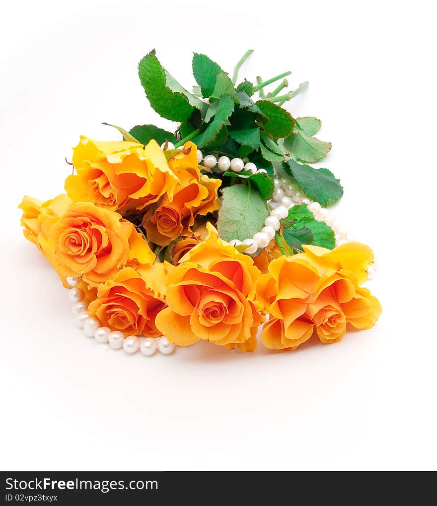 Bouquet of orange roses with a pearl necklace