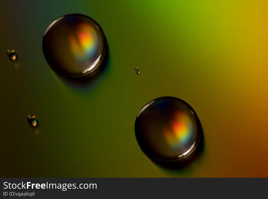 Colorful water drops on a CD in an afternoon sun. Colorful water drops on a CD in an afternoon sun