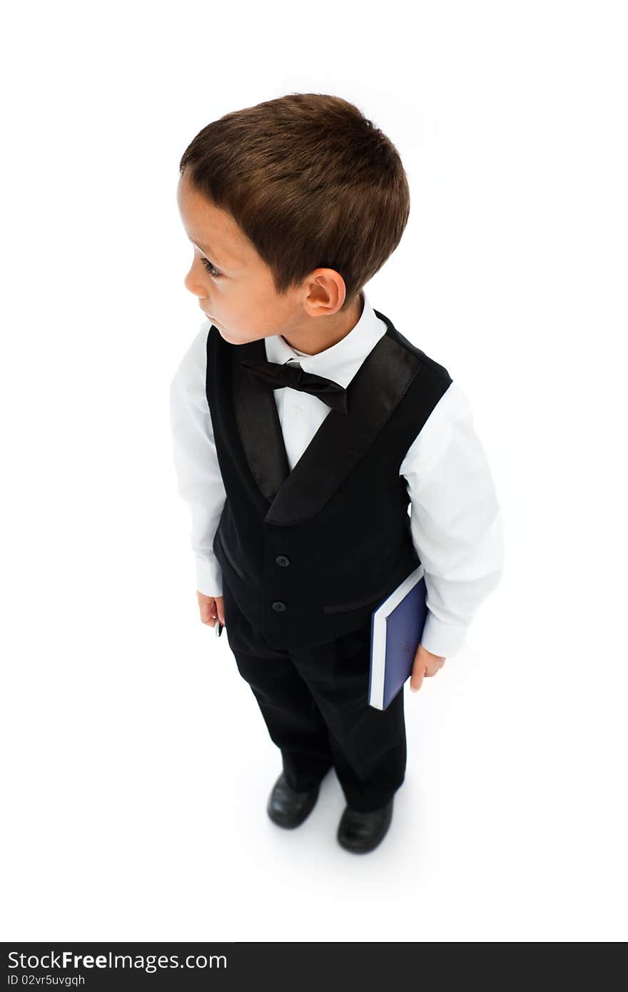 Boy holding pen and book in his hand isolated on white