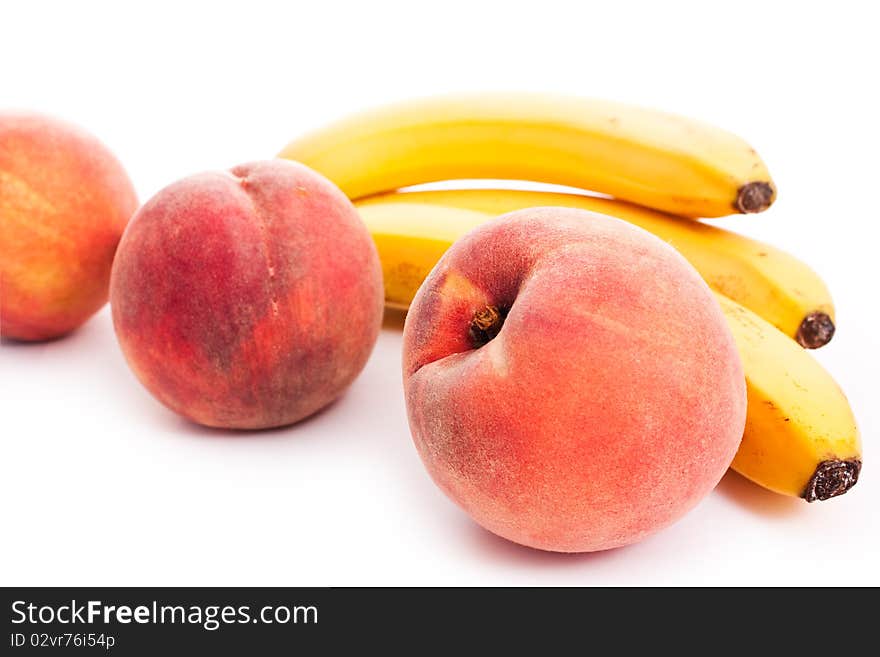 Peaches and bananas isolated on white - vegeterian healthy food