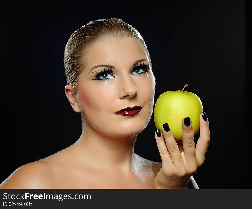 Beautiful woman with bright make-up holding green apple. Beautiful woman with bright make-up holding green apple