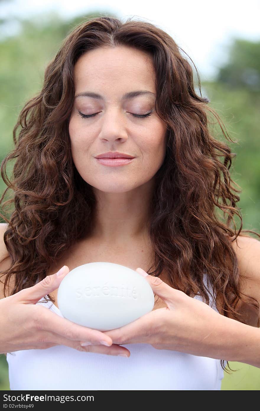 Closeup of beautiful woman holding stone. Closeup of beautiful woman holding stone