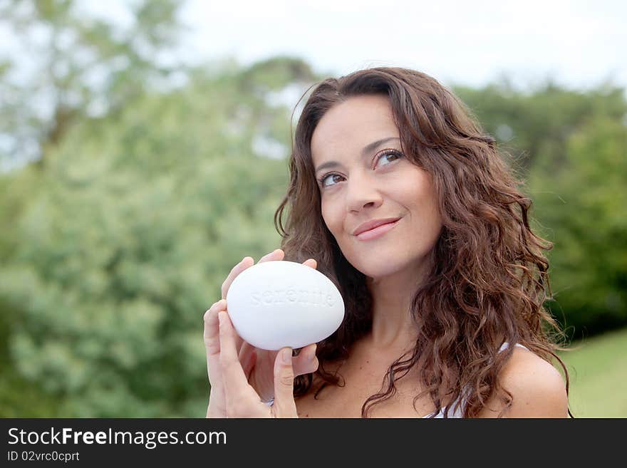 Closeup of beautiful woman holding stone. Closeup of beautiful woman holding stone