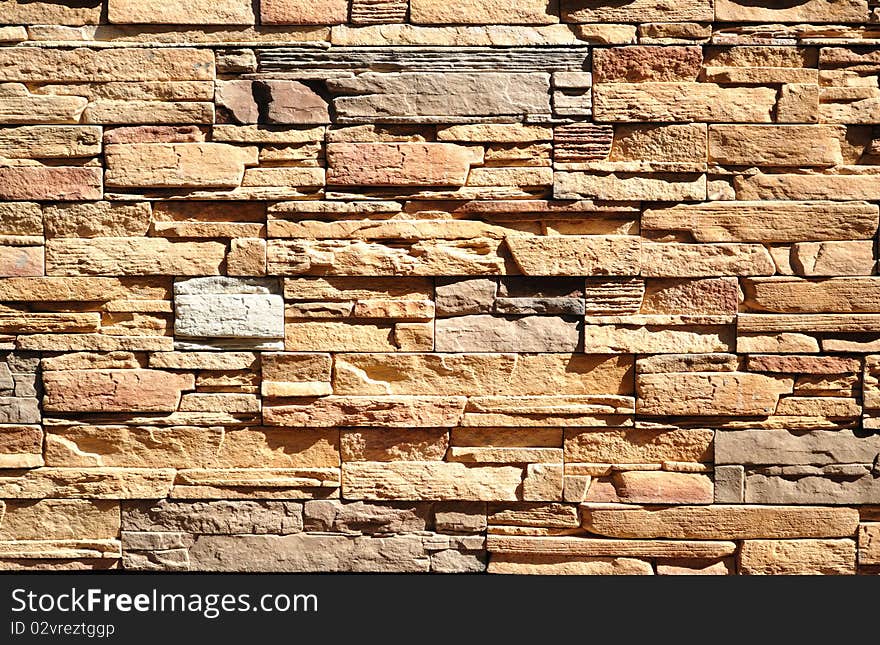 Part of a wall built of bricks of different natural