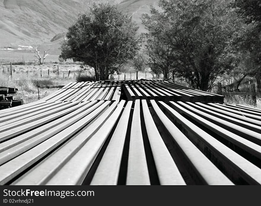 A stack of railroad rails at Laws, California in front of the White Mountains in Inyo County. A stack of railroad rails at Laws, California in front of the White Mountains in Inyo County.