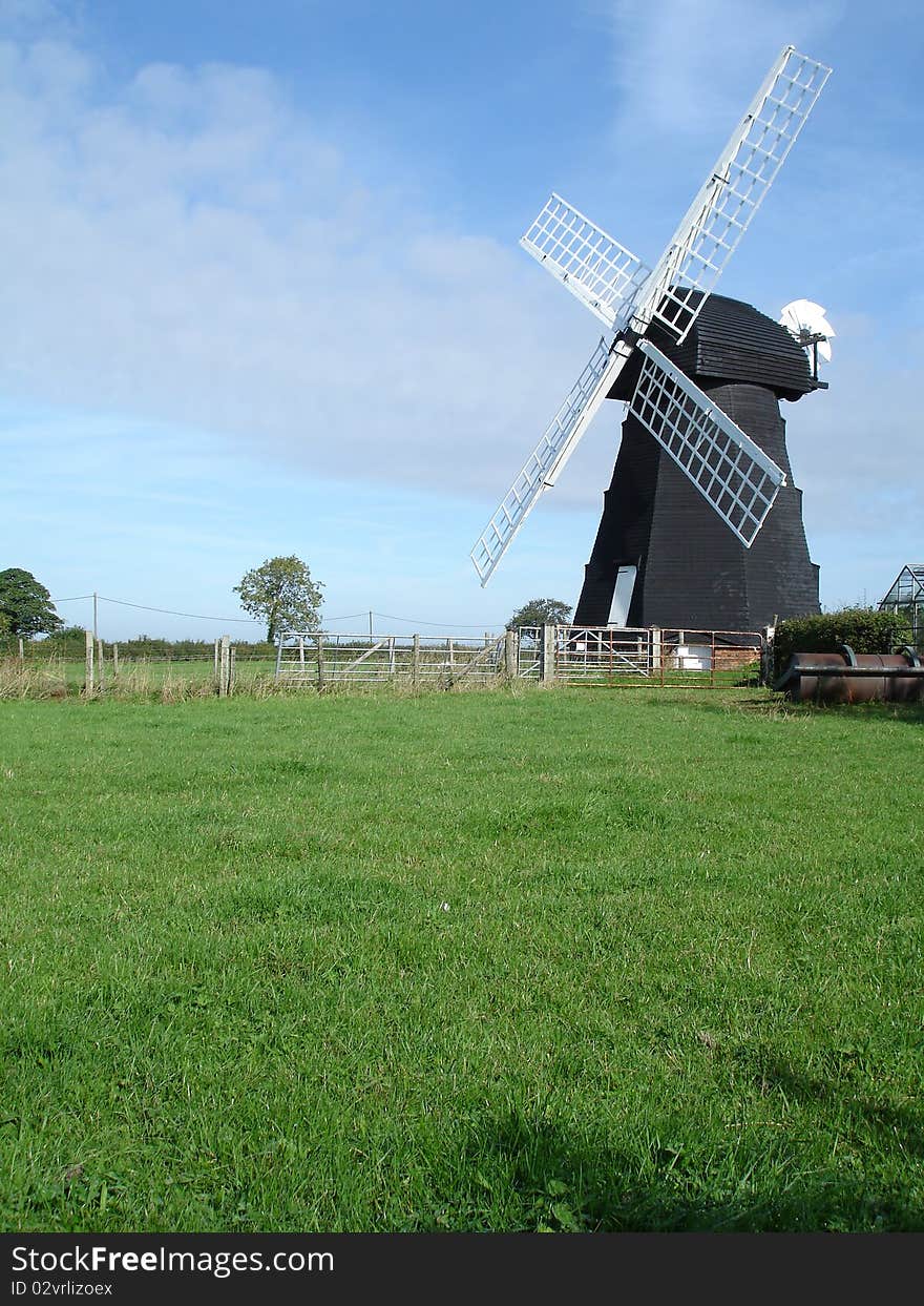 English windmill in a summer landscape. English windmill in a summer landscape