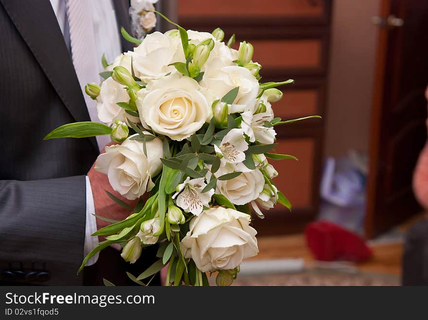 Beautiful bouquet from white roses in man's hand. Beautiful bouquet from white roses in man's hand