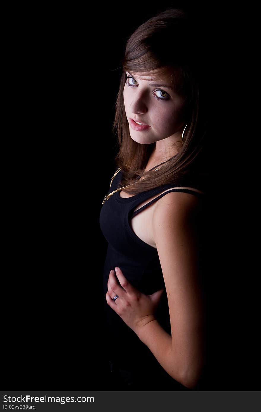 Young stylish trendy teenager over black background with a cute look.